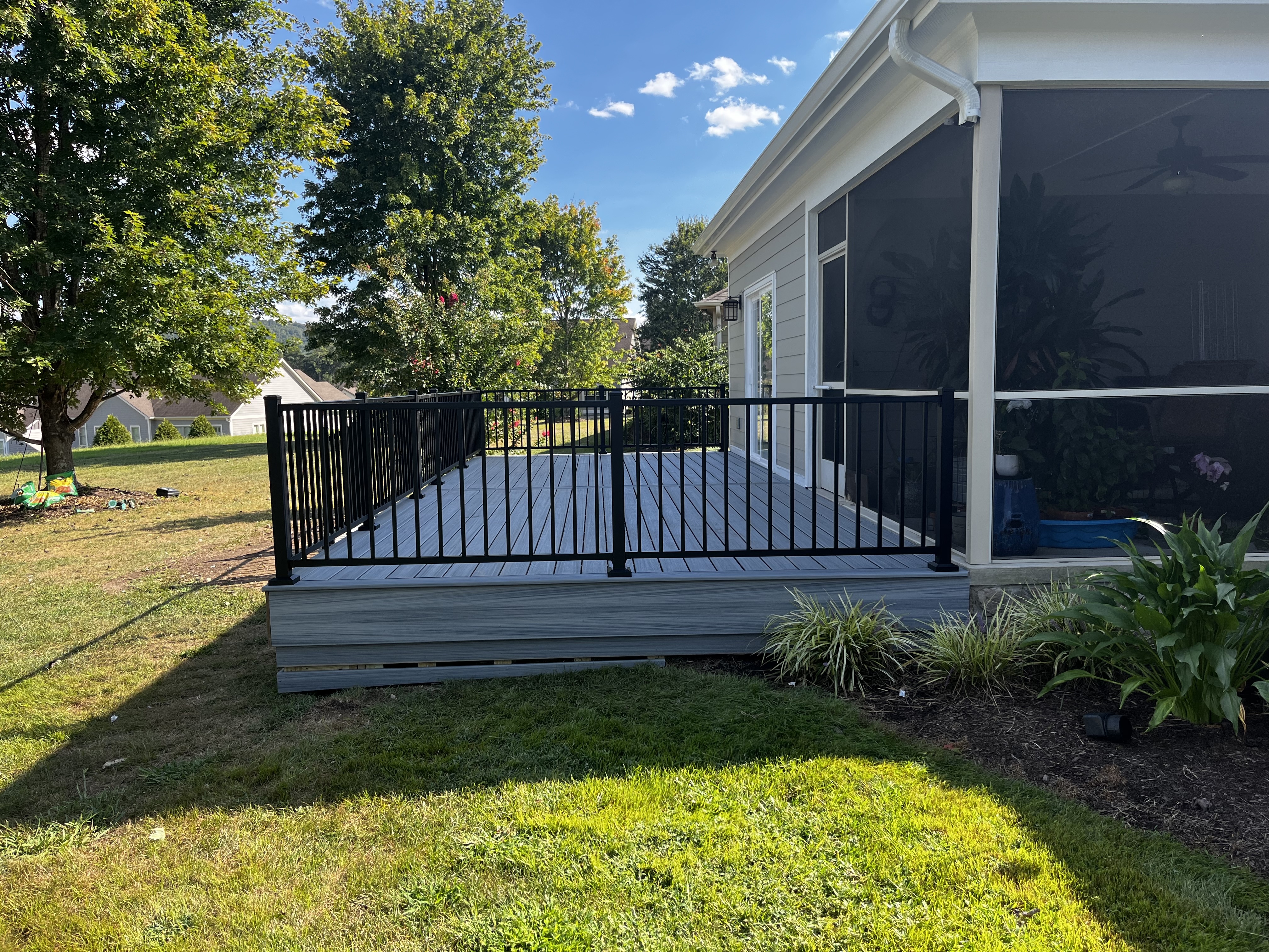 Remodel of an existing deck beside a screened porch